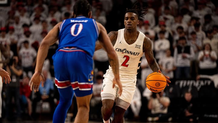 Cincinnati Bearcats guard Jizzle James (2) drives on Kansas Jayhawks guard Shakeel Moore (0) in the second half of the NCAA basketball game at Fifth Third Arena in Cincinnati on Saturday, January 11, 2025. Cincinnati Bearcats guard Jizzle James (2) drives on Kansas Jayhawks guard Shakeel Moore (0) in the second half of the NCAA basketball game at Fifth Third Arena in Cincinnati on Saturday, January 11, 2025.