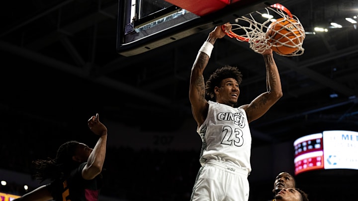 Cincinnati Bearcats forward Dillon Mitchell (23) dunks over Arizona State Sun Devils forward Basheer Jihad (8) and Arizona State Sun Devils guard/forward Amier Ali (5) in the first half of the NCAA basketball game at Fifth Third Arena in Cincinnati on Saturday, January 18, 2025. Cincinnati Bearcats forward Dillon Mitchell (23) dunks over Arizona State Sun Devils forward Basheer Jihad (8) and Arizona State Sun Devils guard/forward Amier Ali (5) in the first half of the NCAA basketball game at Fifth Third Arena in Cincinnati on Saturday, January 18, 2025.