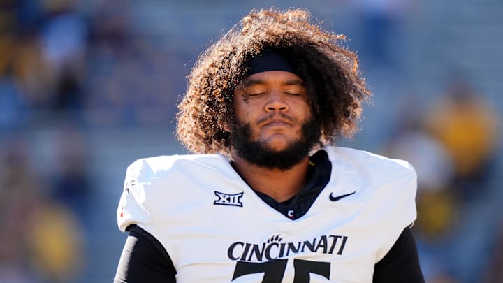 Cincinnati Bearcats offensive lineman John Williams (75) gets prepared prior to an NCAA college football game between the Cincinnati Bearcats and the West Virginia Mountaineers, Saturday, Nov. 18, 2023, at Milan Puskar Stadium in Morgantown, W. Va.