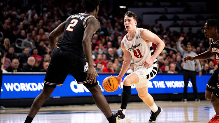 Cincinnati Bearcats guard Simas Lukosius (41) drives on Oklahoma State Cowboys forward Eric Dailey Jr. (2) in the second half of the NCAA basketball game between Cincinnati Bearcats and Oklahoma State Cowboys at Fifth Third Arena in Cincinnati on Wednesday, Feb. 21, 2024.