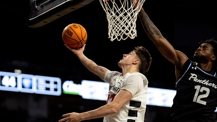 Cincinnati Bearcats guard Jordi Rodriguez (17) hits a layup around Georgia State Panthers forward Anthony Enoh (12) in the second half of the NCAA basketball game at Fifth Third Arena in Cincinnati on Nov. 7, 2025.