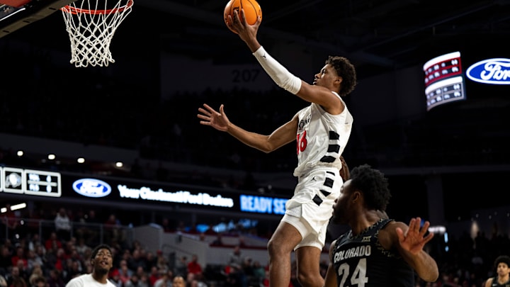 Cincinnati Bearcats forward Baba Miller (18) hits a layup over Colorado Buffaloes guard Barrington Hargress (24) in the first half of the NCAA Basketball game at Fifth Third Arena in Cincinnati on Jan. 14, 2026.