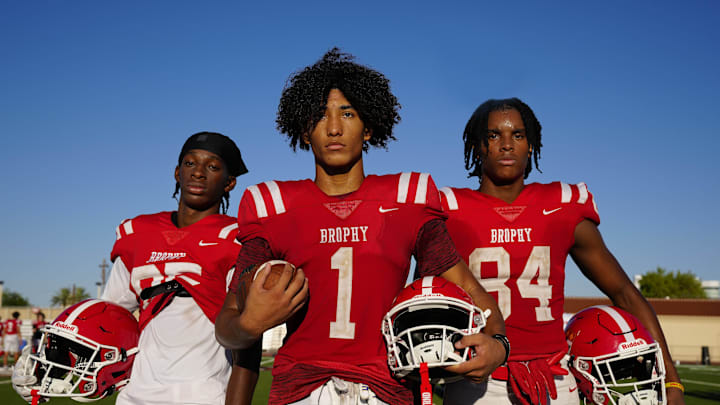 Brophy Prep wide receivers Donovan McNabb Jr. (left to right), Devin Fitzgerald and Daylen Sharper pose for a portrait during a practice at Brophy College Prepatory in Phoenix on Sept. 4, 2024. Brophy Prep wide receivers Donovan McNabb Jr. (left to right), Devin Fitzgerald and Daylen Sharper pose for a portrait during a practice at Brophy College Prepatory in Phoenix on Sept. 4, 2024.
