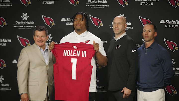 Cardinals defensive lineman Walter Nolen stands and holds his jersey.