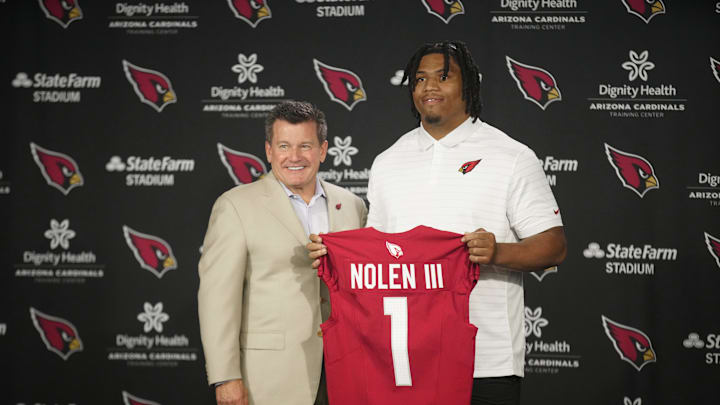 Cardinals defensive lineman Walter Nolen stands and holds his jersey with owner Michael Bidwill.