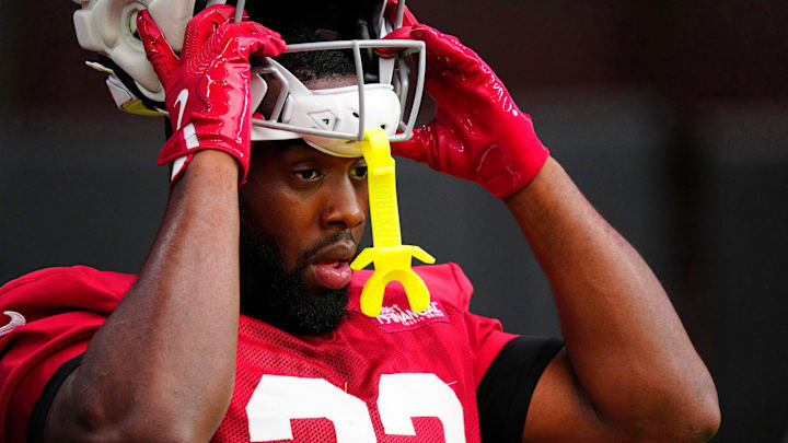 Cardinals running back Trey Benson (33) puts on his helmet during Cardinals training camp at State Farm Stadium in Glendale, on July 31, 2025.