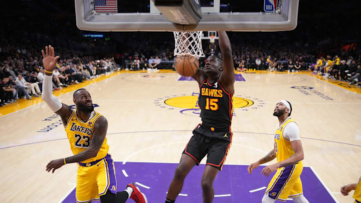 Mar 18, 2024; Los Angeles, California, USA; Atlanta Hawks center Clint Capela (15) dunks the ball against Los Angeles Lakers forward LeBron James (23) and forward Anthony Davis (3) in the first half at Crypto.com Arena. Mandatory Credit: Kirby Lee-Imagn Images