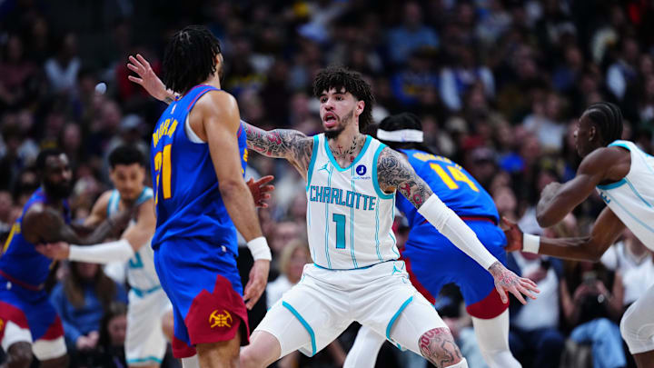 Jan 18, 2026; Denver, Colorado, USA; Charlotte Hornets guard LaMelo Ball (1) defends Denver Nuggets guard Jamal Murray (27) in the first quarter at Ball Arena. Mandatory Credit: Ron Chenoy-Imagn Images
