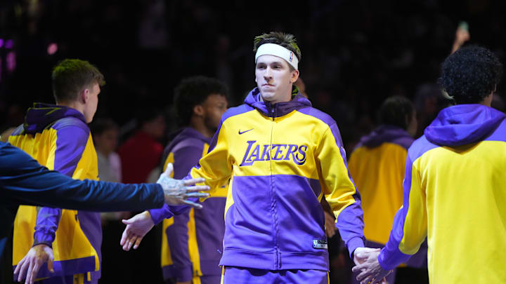 Dec 15, 2024; Los Angeles, California, USA; Los Angeles Lakers guard Austin Reaves (15) is introduced before the game against the Memphis Grizzlies at Crypto.com Arena. Mandatory Credit: Kirby Lee-Imagn Images