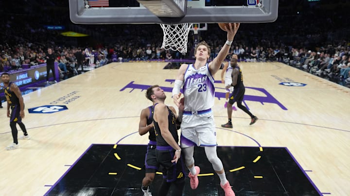 Nov 18, 2025; Los Angeles, California, USA: Utah Jazz forward Lauri Markkanen (23) shoots the ball against Los Angeles Lakers guard Luka Doncic (77) in the second quarter at Crypto.com Arena. Mandatory Credit: Kirby Lee-Imagn Images