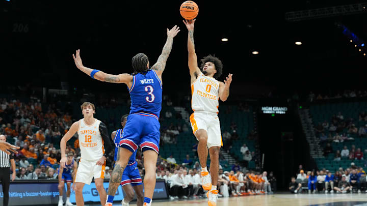 Nov 26, 2025; Las Vegas, NV, USA; Tennessee Volunteers guard Ja’Kobi Gillespie (0) shoots while Kansas Jayhawks guard Tre White (3) defends in the first half in the 2025 Players Era Festival third place game at MGM Grand Garden Arena. Mandatory Credit: Kirby Lee-Imagn Images