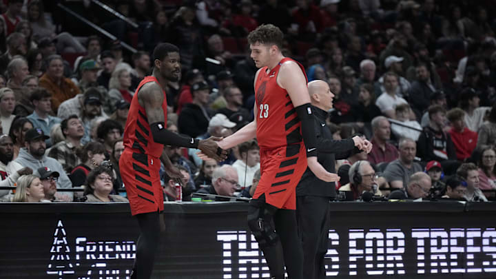 Dec 26, 2024; Portland, Oregon, USA; Portland Trail Blazers center Donovan Clingan (23) high fives Deandre Ayton (2, left) as he heads back to the bench during the first half against the Utah Jazz at Moda Center. Mandatory Credit: Soobum Im-Imagn Images
