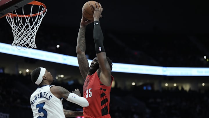 Nov 12, 2024; Portland, Oregon, USA; Portland Trail Blazers center Robert Williams III (35) goes up for a dunk against Minnesota Timberwolves power forward Jaden McDaniels (3) during the first half at Moda Center. Mandatory Credit: Soobum Im-Imagn Images