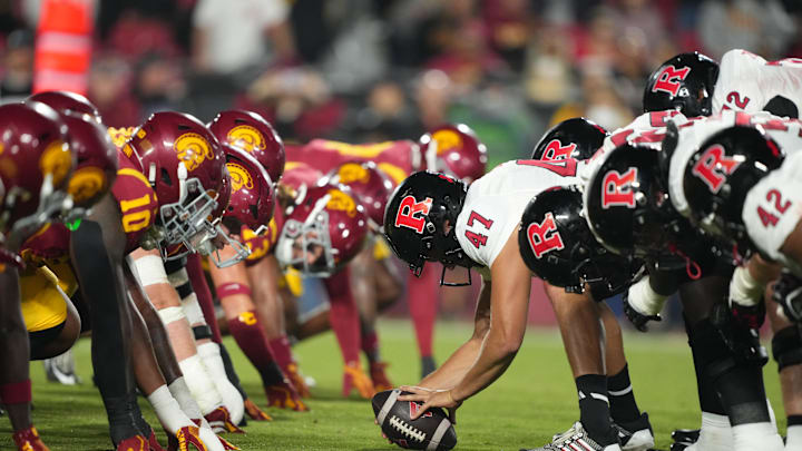 Oct 25, 2024; Los Angeles, California, USA; Helmets at the line of scrimmage as Rutgers Scarlet Knights long snapper Austin Riggs (47) snaps the ball against the Southern California Trojans in the first half at United Airlines Field at Los Angeles Memorial Coliseum. Mandatory Credit: Kirby Lee-Imagn Images Oct 25, 2024; Los Angeles, California, USA; Helmets at the line of scrimmage as Rutgers Scarlet Knights long snapper Austin Riggs (47) snaps the ball against the Southern California Trojans in the first half at United Airlines Field at Los Angeles Memorial Coliseum. Mandatory Credit: Kirby Lee-Imagn Images