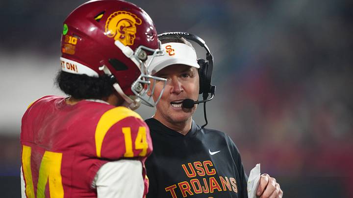 Nov 29, 2025; Los Angeles, California, USA; Southern California Trojans head coach Lincoln Riley (right) talks with quarterback Jayden Maiava (14) in the second half against the UCLA Bruins at United Airlines Field at Los Angeles Memorial Coliseum. Mandatory Credit: Kirby Lee-Imagn Images