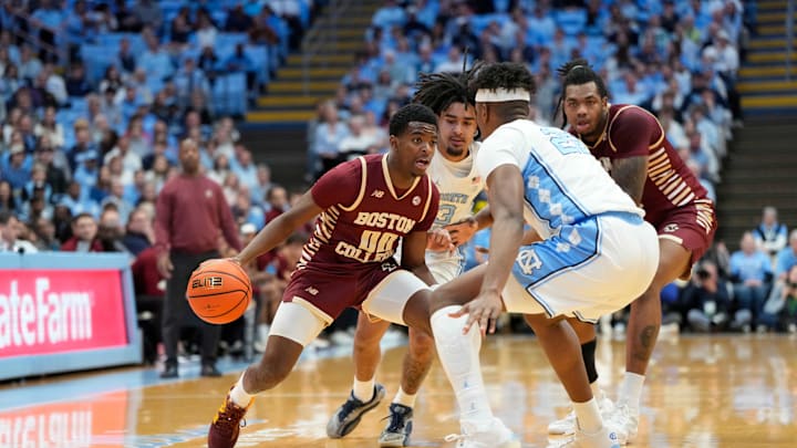 Jan 25, 2025; Chapel Hill, North Carolina, USA; Boston College Eagles guard Chas Kelly III (00) with the ball as North Carolina Tar Heels forward Ven-Allen Lubin (22) defends in the first half at Dean E. Smith Center. Mandatory Credit: Bob Donnan-Imagn Images