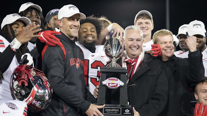 Western Kentucky Hilltoppers head coach Tyson Helton holds the trophy Western Kentucky Hilltoppers head coach Tyson Helton holds the trophy