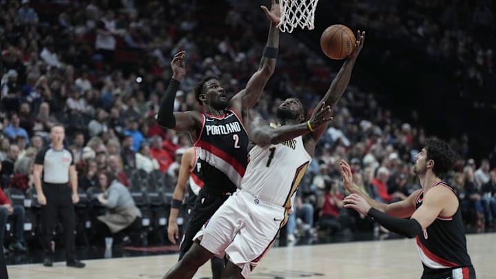 Oct 25, 2024; Portland, Oregon, USA; New Orleans Pelicans power forward Zion Williamson (1) shoots the ball against Portland Trail Blazers center Deandre Ayton (2) during the second half at Moda Center. Mandatory Credit: Soobum Im-Imagn Images