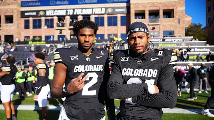 Nov 29, 2024; Boulder, Colorado, USA; Colorado Buffaloes quarterback Shedeur Sanders (2) and safety Shilo Sanders (21) pose for a photo before the game against the Oklahoma State Cowboys at Folsom Field.