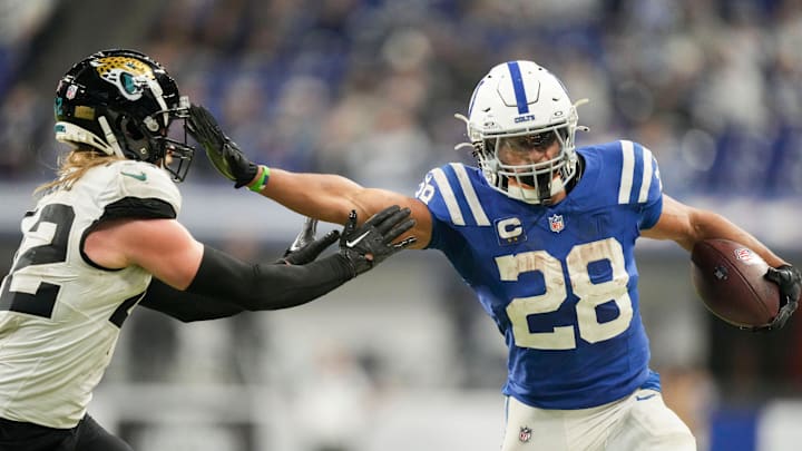 Indianapolis Colts running back Jonathan Taylor (28) pushes off Jacksonville Jaguars cornerback De'Antre Prince (24) as he rushes the ball Sunday, Jan. 5, 2025, during a game against the Jacksonville Jaguars at Lucas Oil Stadium in Indianapolis.