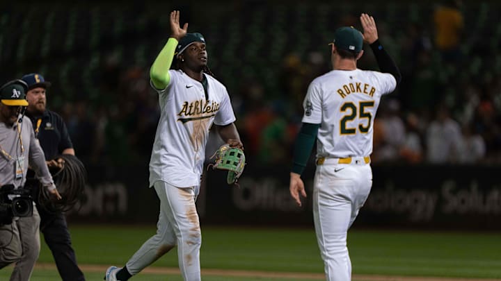 Jul 23, 2024; Oakland, California, USA; Oakland Athletics outfielder Lawrence Butler (4) and outfielder Brent Rooker (25) celebrate after defeating the Houston Astros at Oakland-Alameda County Coliseum.