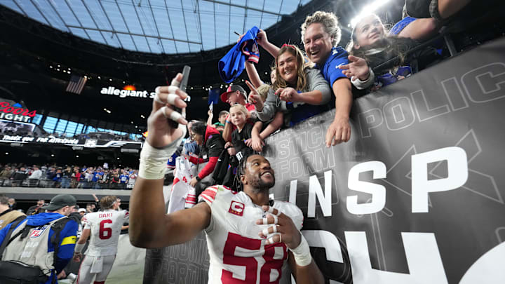 Dec 28, 2025; Paradise, Nevada, USA; New York Giants inside linebacker Bobby Okereke (58) takes a photo with fans after the game against the Las Vegas Raiders at Allegiant Stadium.  