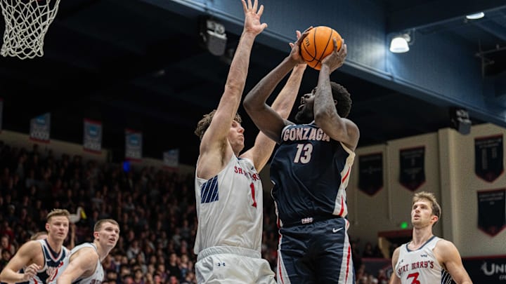 Gonzaga Bulldogs forward Graham Ike (13) drives to the net while being defended by St. Mary's Gaels center Harry Wessels (1)