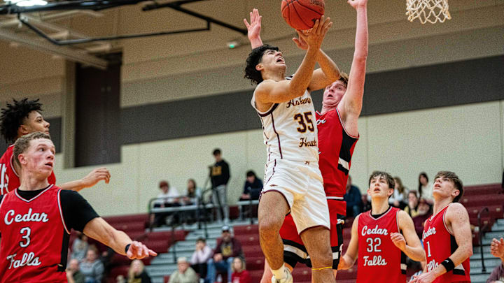 Ankeny's Rio Aguirre (35) takes a shot at the basket while guarded by Cedar Falls' Leyton Wolf (33) on Thursday, Dec. 19, 2024, at Ankeny High School. Ankeny's Rio Aguirre (35) takes a shot at the basket while guarded by Cedar Falls' Leyton Wolf (33) on Thursday, Dec. 19, 2024, at Ankeny High School.