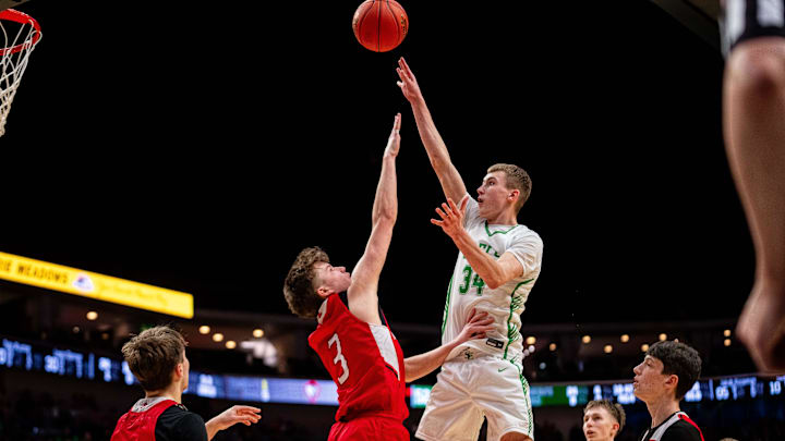St. Edmond's Hunter Horn (34) takes a shot against Marquette Catholic's Taegin Smith (3) on March 13, 2026, at Casey’s Center in Des Moines.