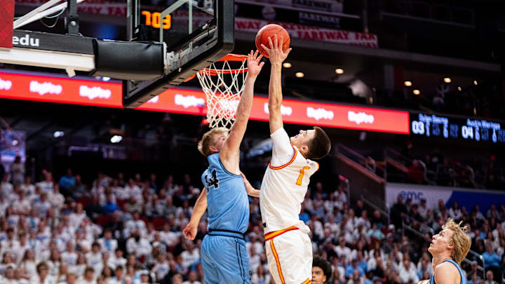 Kuemper Catholic's Dylan Schon (1) shoots the ball against Unity Christian's Brayden Harskamp (14) on March 13, 2026, at Casey’s Center in Des Moines. Kuemper Catholic's Dylan Schon (1) shoots the ball against Unity Christian's Brayden Harskamp (14) on March 13, 2026, at Casey’s Center in Des Moines.