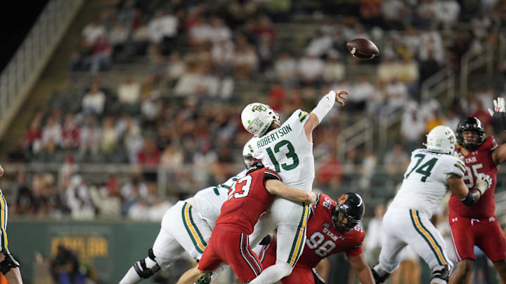 Nov 15, 2025; Waco, Texas, USA;  Baylor Bears quarterback Sawyer Robertson (13) is pressured by Utah Utes safety Jackson Bennee (23) during the second half at McLane Stadium. Mandatory Credit: Chris Jones-Imagn Images
