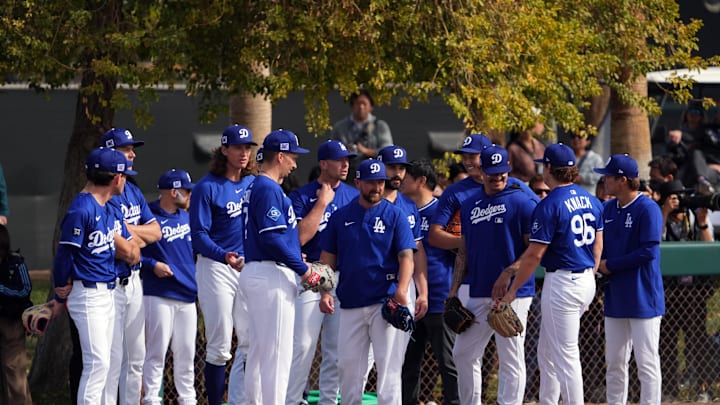 Feb 16, 2025; Glendale, AZ, USA; Los Angeles Dodgers pitchers talk during a Spring Training workout at Camelback Ranch. Mandatory Credit: Joe Camporeale-Imagn Images