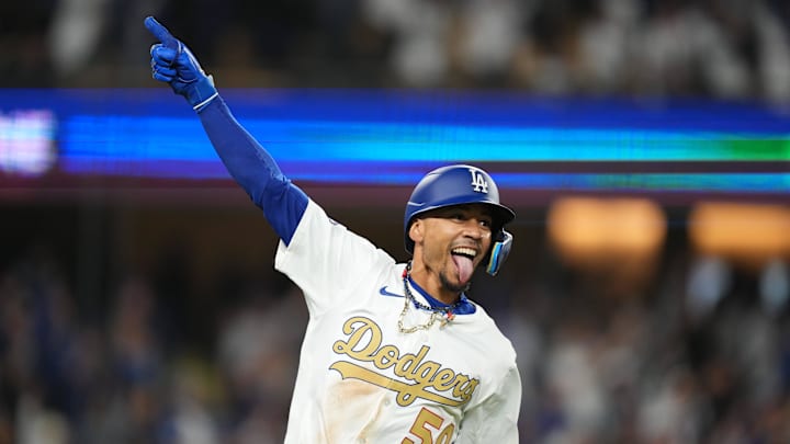 Mar 28, 2025; Los Angeles, California, USA;  Los Angeles Dodgers shortstop Mookie Betts (50) hits a 3 run home run during the tenth inning against the Detroit Tigers at Dodger Stadium. Mandatory Credit: Kirby Lee-Imagn Images