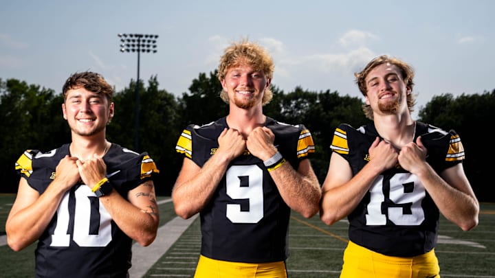 Quarterbacks Jeremy Hecklinski, Hank Brown and Jackson Stratton stand for a photo as Iowa Football hosts media day on Aug. 8, 2025, in Iowa City.