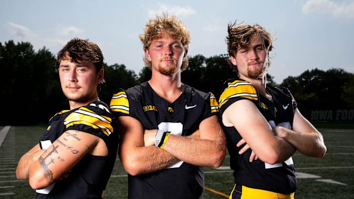 Quarterbacks Jeremy Hecklinski, Hank Brown and Jackson Stratton stand for a photo as Iowa Football hosts media day on Aug. 8, 2025, in Iowa City.