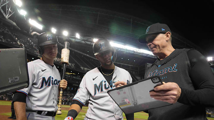 Miami Marlins hitting coach Brant Brown (right) talks with Miami Marlins first baseman Yuli Gurriel (middle) and Miami Marlins shortstop Joey Wendle (left) during the eighth inning of the game against the Arizona Diamondbacks at Chase Field in 2023.