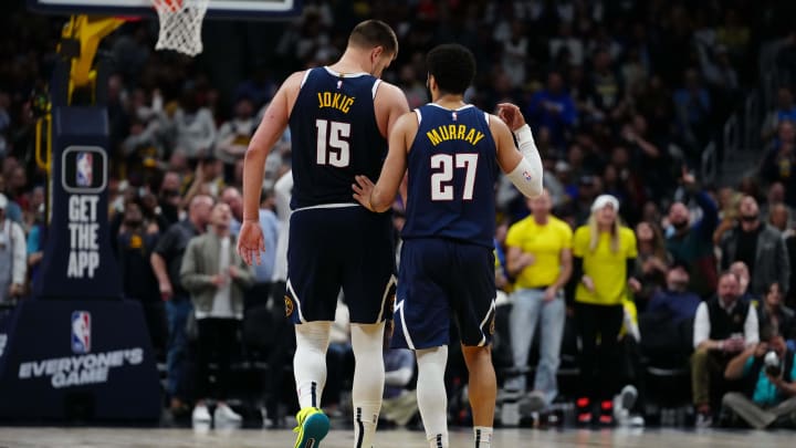 Apr 10, 2024; Denver, Colorado, USA; Denver Nuggets center Nikola Jokic (15) and guard Jamal Murray (27) talk in the fourth quarter against the Minnesota Timberwolves at Ball Arena. Mandatory Credit: Ron Chenoy-USA TODAY Sports