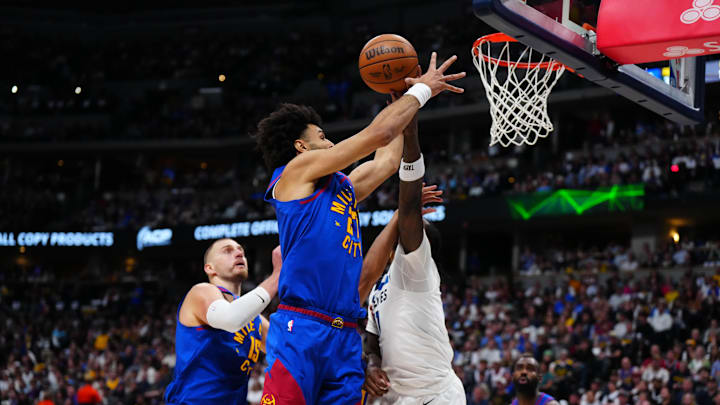 Apr 20, 2026; Denver, Colorado, USA; Minnesota Timberwolves center Naz Reid (11) and Denver Nuggets guard Jamal Murray (27) reach for a rebound in the first half during game two of the first round of the 2026 NBA Playoffs at Ball Arena. Mandatory Credit: Ron Chenoy-Imagn Images
