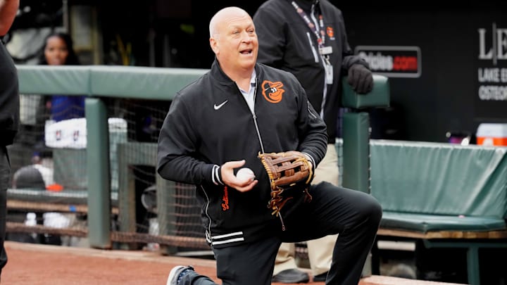Mar 28, 2024; Baltimore, Maryland, USA; Baltimore Orioles legend Cal Ripken Jr warms up Aubree Singletary (not shown) before she threw out the pre-game ceremonial first pitch against the Los Angeles Angels at Oriole Park at Camden Yards.