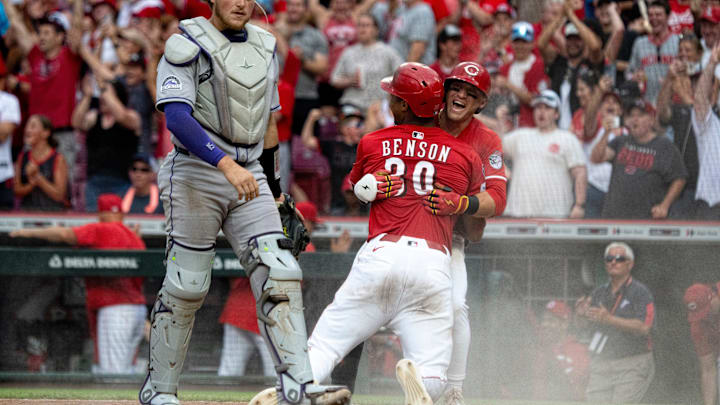 Cincinnati Reds center fielder TJ Friedl (29) celebrates with Cincinnati Reds right fielder Will Benson (30) after he scored on a fielding error by Colorado Rockies shortstop Orlando Arcia (11) in the ninth inning between Cincinnati Reds and Colorado Rockies at Great American Ball Park in Cincinnati on Saturday, July 12, 2025.