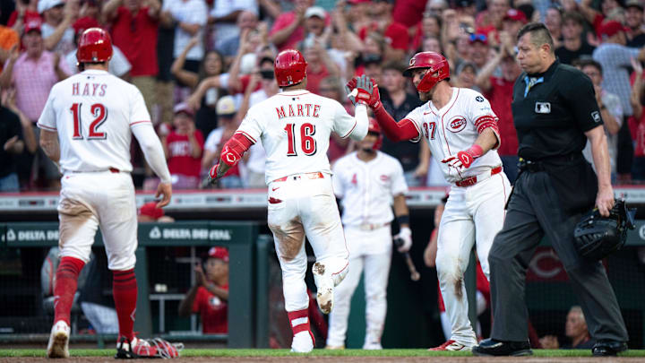 Cincinnati Reds third baseman Noelvi Marte (16) high fives Cincinnati Reds catcher Tyler Stevenson (37) after scoring on a double with a fielders choice and an error in the sixth inning between Cincinnati Reds and Philadelphia Phillies at Great American Ball Park in Cincinnati on Aug. 13, 2025.
