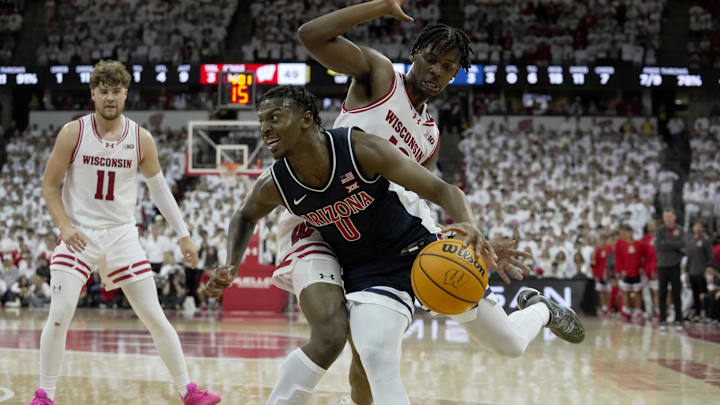 Arizona guard Jaden Bradley (0) is fouled by Wisconsin forward Xavier Amos (13) during the first half of their game Friday, November 15, 2024 at the Kohl Center in Madison, Wisconsin.