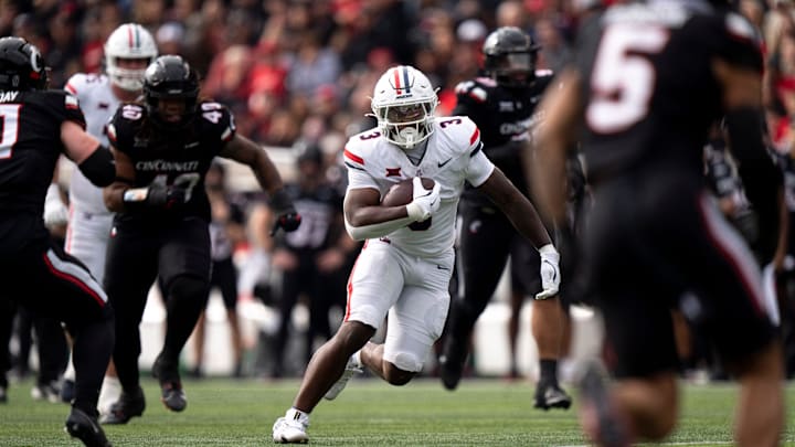 Arizona Wildcats running back Kedrick Reescano (3) runs the ball in the first quarter of the NCAA football game between the Cincinnati Bearcats and Arizona Wildcats at Nippert Stadium in Cincinnati on Nov. 15, 2025.