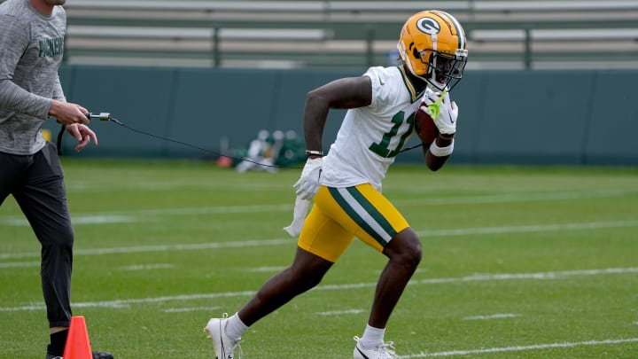Green Bay Packers wide receiver Jayden Reed does a ball-security drill during minicamp. 