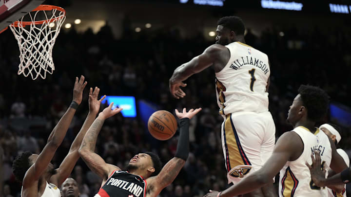; New Orleans Pelicans power forward Zion Williamson (1) blocks a shot by Portland Trail Blazers shooting guard Anfernee Simons (1) during the second half at Moda Center. Mandatory Credit: Soobum Im-Imagn Images