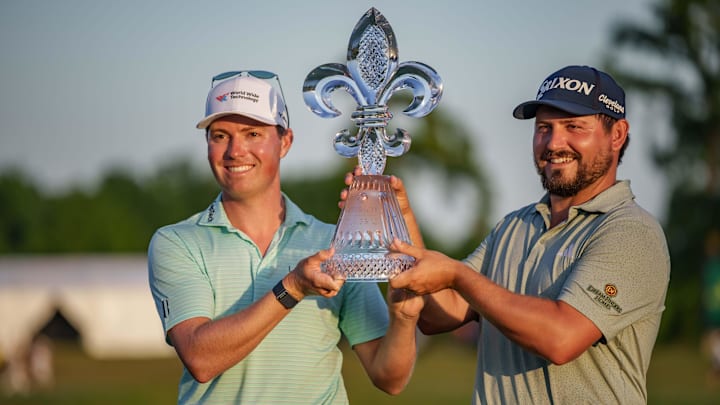 Apr 27, 2025; Avondale, Louisiana, USA; Ben Griffin, left, celebrates with teammate Andrew Novak after winning on the 18th hole during the final round of the Zurich Classic of New Orleans golf tournament. Mandatory Credit: Matthew Hinton-Imagn Images