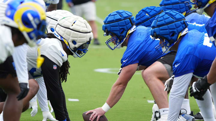 May 28, 2025; Woodland Hills, CA, USA; A general overall view of the line of scrimmage as Los Angeles Rams center Coleman Shelton (65) takes the snap during organized team activities at Rams Practice Facility. Mandatory Credit: Kirby Lee-Imagn Images