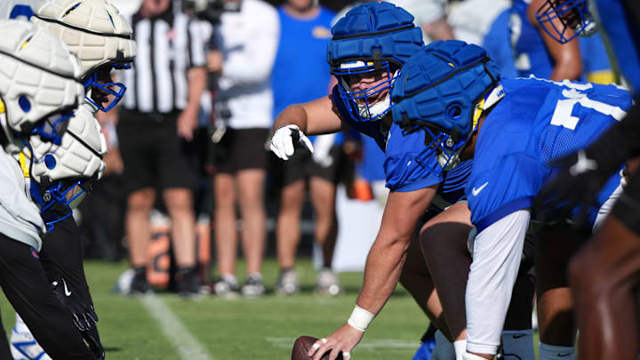 Jul 23, 2025; Los Angeles, CA, USA; Los Angeles Rams lineman Coleman Shelton (65) snaps the ball at the line fo scrimmage during training camp at Loyola Marymount University. Mandatory Credit: Kirby Lee-Imagn Images