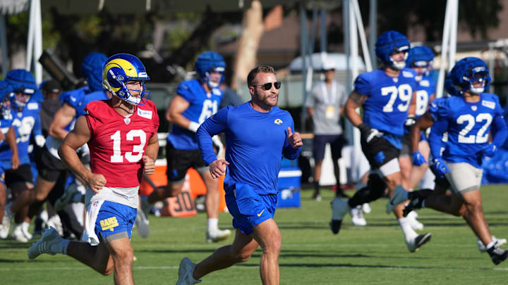 Jul 23, 2025; Los Angeles, CA, USA; Los Angeles Rams coach Sean McVay runs with quarterback Stetson Bennett (13) during training camp at Loyola Marymount University. Mandatory Credit: Kirby Lee-Imagn Images Jul 23, 2025; Los Angeles, CA, USA; Los Angeles Rams coach Sean McVay runs with quarterback Stetson Bennett (13) during training camp at Loyola Marymount University. Mandatory Credit: Kirby Lee-Imagn Images
