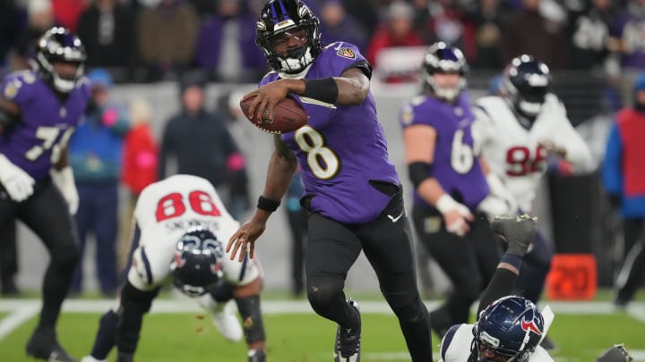 Jan 20, 2024; Baltimore, MD, USA; Baltimore Ravens quarterback Lamar Jackson (8) runs the ball against Houston Texans defensive end Jonathan Greenard (52) during the second quarter of a 2024 AFC divisional round game at M&T Bank Stadium. Mandatory Credit: Mitch Stringer-USA TODAY Sports Jan 20, 2024; Baltimore, MD, USA; Baltimore Ravens quarterback Lamar Jackson (8) runs the ball against Houston Texans defensive end Jonathan Greenard (52) during the second quarter of a 2024 AFC divisional round game at M&T Bank Stadium. Mandatory Credit: Mitch Stringer-USA TODAY Sports